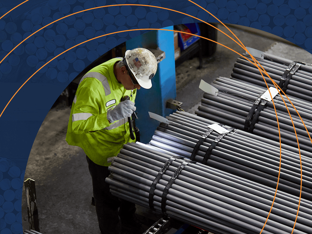 man-inspecting-charter-steel-manufactured-steel-rods.png man inspecting charter steel manufactured steel rods